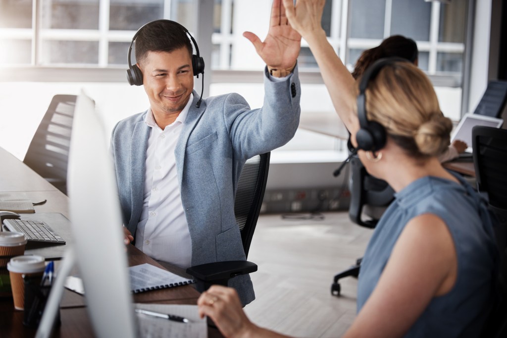 Customer support high five, consulting and happy people celebrate telemarketing on contact us CRM or ERP telecom. Call center achievement, ecommerce team and excited information technology consultant