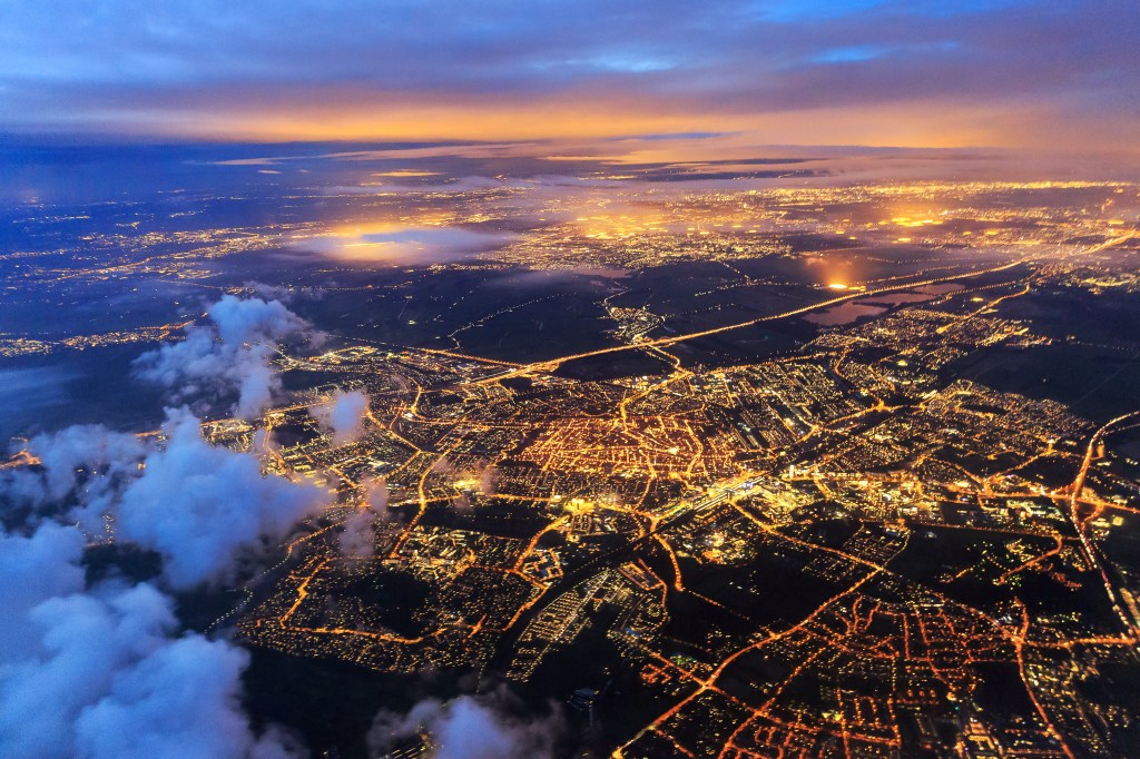 Beautiful aerial cityscape view of the city of Leiden, the Netherlands, after sunset at night in the blue hour